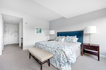 a bedroom with a blue and white bed and white carpet at HIGHGROVE, Stamford, CT
